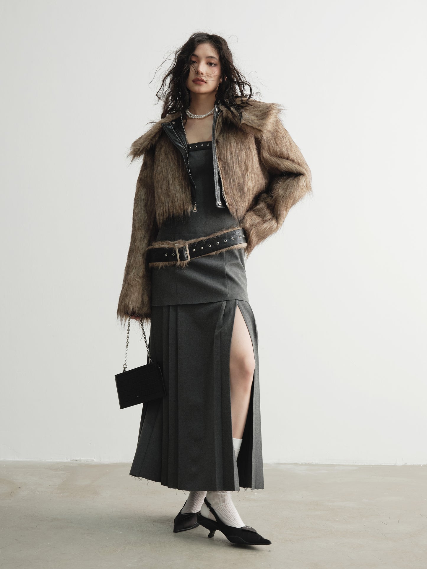 Model wearing Ara Ato's reversible Alix Jacket with the brown fur side on the exterior and black leather side on the interior.